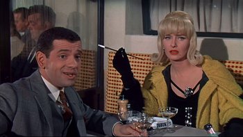 Movie still from “A New Kind of Love” (1963), directed by Melville Shavelson – A man and a woman sitting at a dinner table; Medium shot, High angle