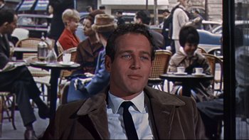 Movie still from “A New Kind of Love” (1963), directed by Melville Shavelson – A person wearing a suit and tie; Medium shot, Over the shoulder angle