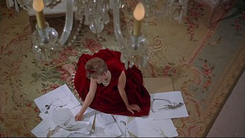 Movie still from “A New Kind of Love” (1963), directed by Melville Shavelson – A little girl sitting on the floor in front of a chandelier; Wide shot, High angle