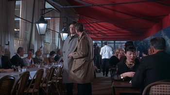 Movie still from “A New Kind of Love” (1963), directed by Melville Shavelson – A group of people sitting at tables in an outdoor restaurant; Wide shot, High angle
