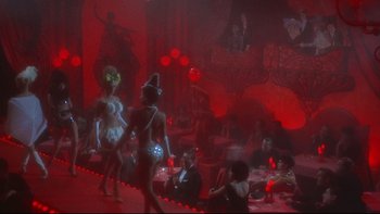 Movie still from “A New Kind of Love” (1963), directed by Melville Shavelson – A group of people sitting at tables in a room; Wide shot, High angle