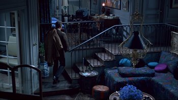 Movie still from “A New Kind of Love” (1963), directed by Melville Shavelson – A man walking down the stairs of a living room; Wide shot, Overhead angle