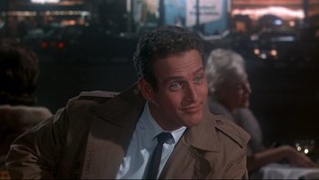 Movie still from “A New Kind of Love” (1963), directed by Melville Shavelson – A person wearing a suit and tie; Close Up shot, Over the shoulder angle