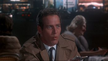 Movie still from “A New Kind of Love” (1963), directed by Melville Shavelson – A person wearing a suit and tie; Close Up shot, Over the shoulder angle