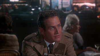 Movie still from “A New Kind of Love” (1963), directed by Melville Shavelson – A person wearing a suit and tie; Close Up shot, Over the shoulder angle