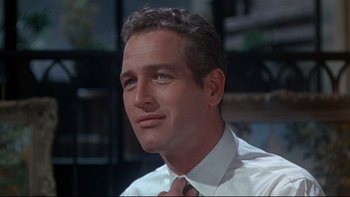 Movie still from “A New Kind of Love” (1963), directed by Melville Shavelson – A person wearing a shirt and a tie; Close Up shot, Over the shoulder angle