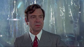 Movie still from “A New Leaf” (1971), directed by Elaine May – A person wearing a suit and tie; Close Up shot, Low angle