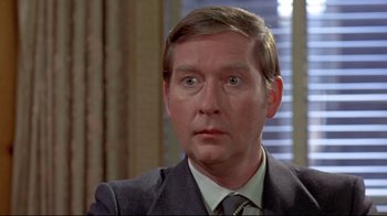 Movie still from “A New Leaf” (1971), directed by Elaine May – A person wearing a suit and tie; Close Up shot, Low angle