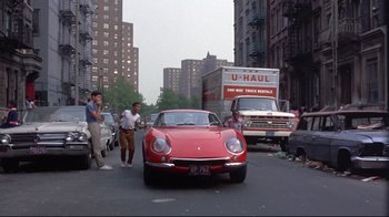 Movie still from “A New Leaf” (1971), directed by Elaine May – A man standing on the side of the road next to a red sports car; Wide shot, Low angle
