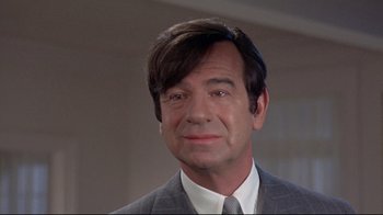 Movie still from “A New Leaf” (1971), directed by Elaine May – A person wearing a suit and tie; Close Up shot, Over the shoulder angle