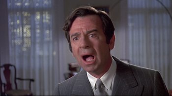 Movie still from “A New Leaf” (1971), directed by Elaine May – A person wearing a suit and tie; Close Up shot, Low angle