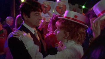Movie still from “A New Leaf” (1971), directed by Elaine May – A man and a woman are dancing together at an event; Medium shot, Over the shoulder angle