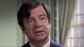 Movie still from “A New Leaf” (1971), directed by Elaine May – A person wearing a suit and tie; Close Up shot, Over the shoulder angle