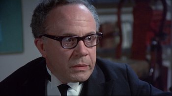 Movie still from “A New Leaf” (1971), directed by Elaine May – An older man wearing a suit and glasses; Close Up shot, Low angle
