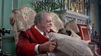 Movie still from “A New Leaf” (1971), directed by Elaine May – An old man sitting on a couch holding a newspaper; Medium shot, Over the shoulder angle