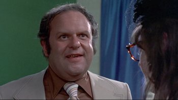 Movie still from “A New Leaf” (1971), directed by Elaine May – A person wearing a suit and a tie; Close Up shot, Over the shoulder angle