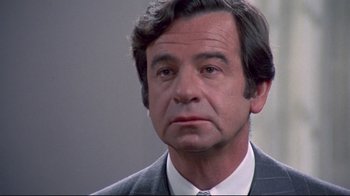 Movie still from “A New Leaf” (1971), directed by Elaine May – An older man in a suit and tie looking to his left; Close Up shot, Over the shoulder angle