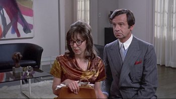 Movie still from “A New Leaf” (1971), directed by Elaine May – A man and a woman standing next to each other in a room; Medium shot, Over the shoulder angle