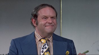 Movie still from “A New Leaf” (1971), directed by Elaine May – A person wearing a suit and tie; Close Up shot, Low angle