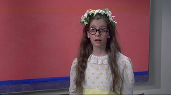 Movie still from “A New Leaf” (1971), directed by Elaine May – A young girl wearing glasses and a flower crown; Medium shot, High angle