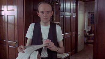 Movie still from “A New Leaf” (1971), directed by Elaine May – A man holding a bunch of playing cards in his hand; Close Up shot, Over the shoulder angle