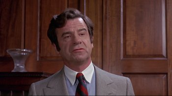 Movie still from “A New Leaf” (1971), directed by Elaine May – A person wearing a suit and a tie; Close Up shot, Low angle
