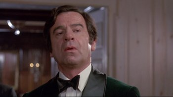 Movie still from “A New Leaf” (1971), directed by Elaine May – A person wearing a suit and a bow tie; Close Up shot, Low angle