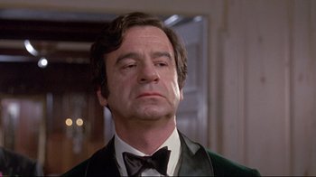 Movie still from “A New Leaf” (1971), directed by Elaine May – A person wearing a suit and bow tie; Close Up shot, Low angle