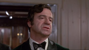 Movie still from “A New Leaf” (1971), directed by Elaine May – A person wearing a suit and bow tie; Close Up shot, Low angle