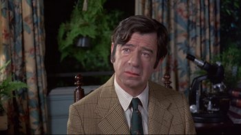 Movie still from “A New Leaf” (1971), directed by Elaine May – A person wearing a suit and tie; Close Up shot, Over the shoulder angle