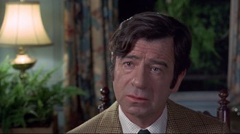 Movie still from “A New Leaf” (1971), directed by Elaine May – A person wearing a suit and tie; Close Up shot, Over the shoulder angle