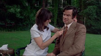 Movie still from “A New Leaf” (1971), directed by Elaine May – A woman is helping a man put on a tie; Medium shot, High angle