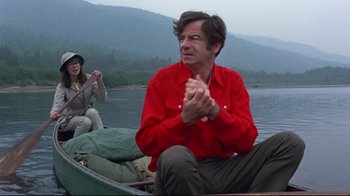 Movie still from “A New Leaf” (1971), directed by Elaine May – A man sitting in a boat on a lake; Medium shot, Low angle