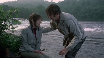 Movie still from “A New Leaf” (1971), directed by Elaine May – A man and a woman in the water by a body of water; Medium shot, Over the shoulder angle