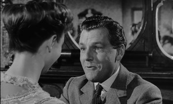 Movie still from “A Night to Remember” (1958), directed by Roy Ward Baker – A black and white photo of a man and a woman; Close Up shot, Over the shoulder angle