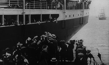 Movie still from “A Night to Remember” (1958), directed by Roy Ward Baker – A black and white photo of people boarding a ship; Extreme Wide shot, High angle