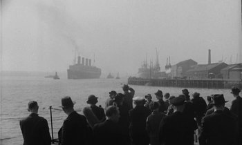 Movie still from “A Night to Remember” (1958), directed by Roy Ward Baker – A group of people standing on a boat in the water; Extreme Wide shot, Low angle