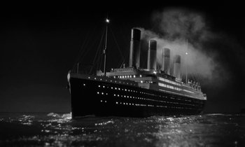 Movie still from “A Night to Remember” (1958), directed by Roy Ward Baker – A black and white photo of a boat in the ocean; Extreme Wide shot, Low angle