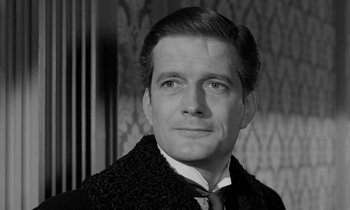 Movie still from “A Night to Remember” (1958), directed by Roy Ward Baker – Black and white photograph of a man wearing a suit; Close Up shot, Low angle