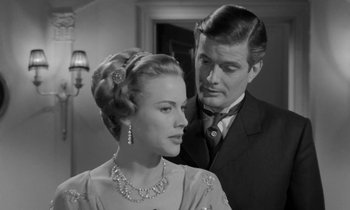Movie still from “A Night to Remember” (1958), directed by Roy Ward Baker – A man and a woman standing next to each other in a room; Close Up shot, Over the shoulder angle