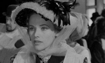 Movie still from “A Night to Remember” (1958), directed by Roy Ward Baker – A black and white photo of a woman wearing a hat; Close Up shot, High angle