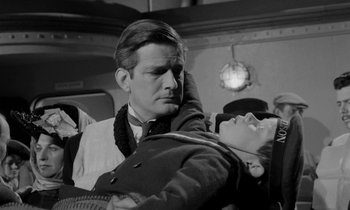 Movie still from “A Night to Remember” (1958), directed by Roy Ward Baker – A black and white photo of a man holding a woman; Medium shot, Over the shoulder angle