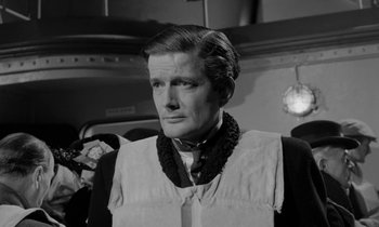 Movie still from “A Night to Remember” (1958), directed by Roy Ward Baker – A black and white photo of a man wearing a neck tie; Close Up shot, Over the shoulder angle