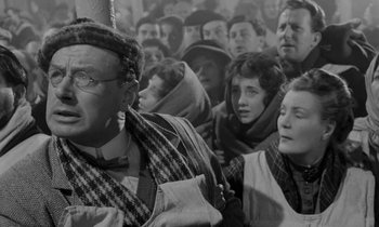Movie still from “A Night to Remember” (1958), directed by Roy Ward Baker – A black and white photo of a group of people; Medium shot, Low angle