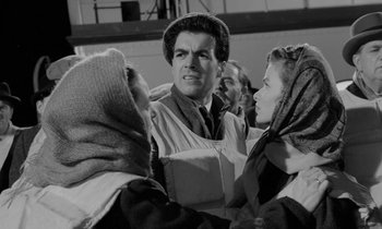 Movie still from “A Night to Remember” (1958), directed by Roy Ward Baker – A group of people standing next to each other; Medium shot, Over the shoulder angle