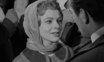 Movie still from “A Night to Remember” (1958), directed by Roy Ward Baker – A black - and - white photo of a woman wearing a head scarf; Close Up shot, Over the shoulder angle