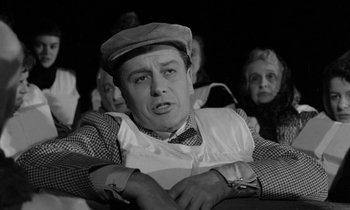 Movie still from “A Night to Remember” (1958), directed by Roy Ward Baker – An old man in a hat and a plaid vest; Medium shot, Low angle