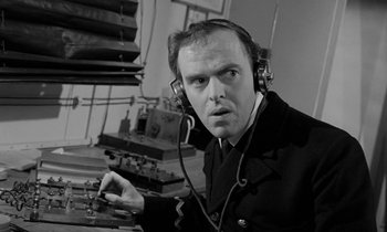 Movie still from “A Night to Remember” (1958), directed by Roy Ward Baker – A man wearing headphones and a jacket; Close Up shot, Low angle