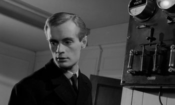 Movie still from “A Night to Remember” (1958), directed by Roy Ward Baker – A black and white photo of a man in a suit and tie; Close Up shot, Low angle