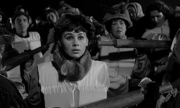 Movie still from “A Night to Remember” (1958), directed by Roy Ward Baker – A black and white photo of a woman in a hat and scarf; Close Up shot, High angle